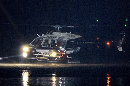 person being rescued from water by helicopter