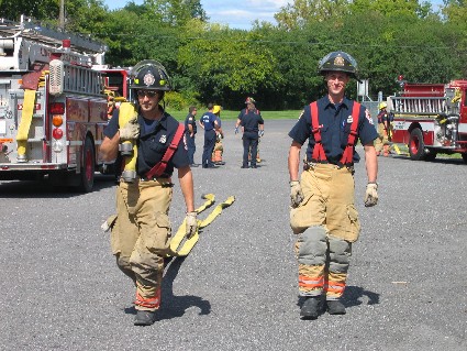 two firefighters with a hose