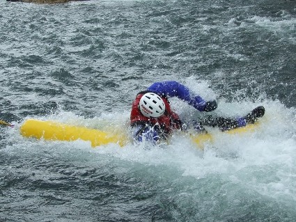 man on a raft in choppy water