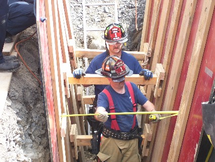 firefighters in a trench