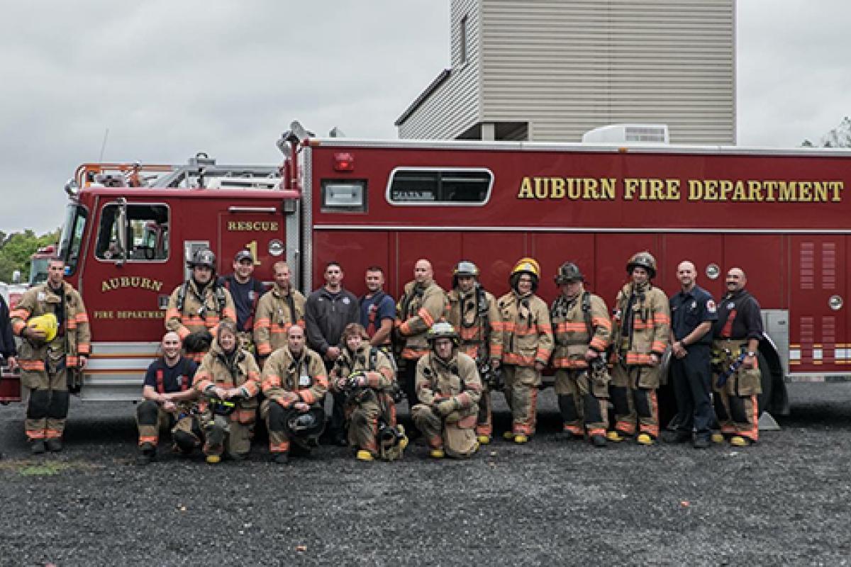 Group of firefighters in front of a firetruck